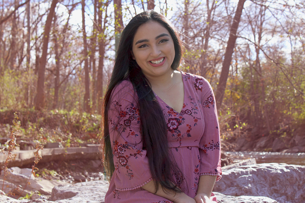 Rocio Figueroa ’22 portrait sitting outside on a rock