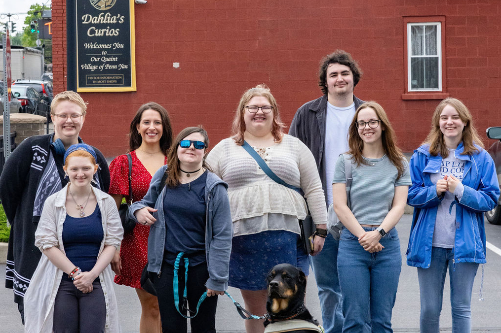 Keuka College students standing in front of the mural they created in downtown Penn Yan