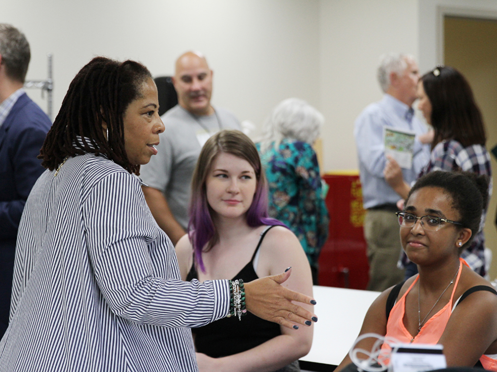 Keuka College Board of Trustees Vice Chair Aqua Porter chats with art students during the opening reception for the new Center for Arts & Design.