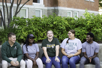 Students sitting in front of Ball Hall 